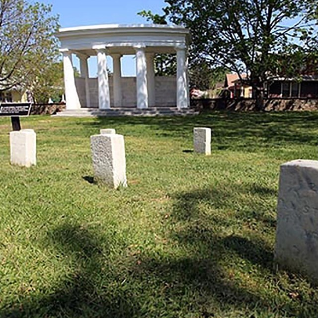 Uniform grave markers and rostrum at Battleground National Cemetery.