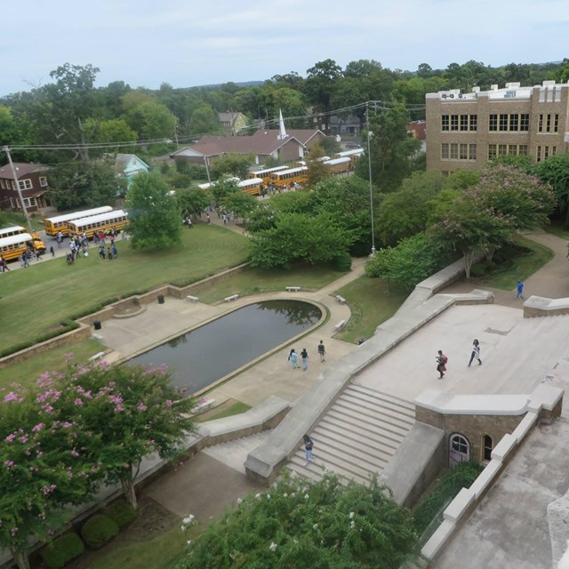 Little Rock Central High School landscape with entry staircase, reflecting pool, lawn and trees.