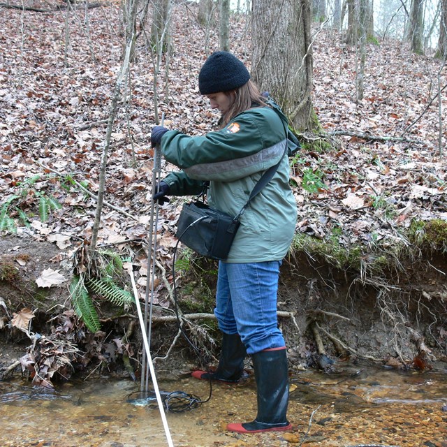 Network biologist Brenda Wells measures stream discharge at Shiloh National Military Park.