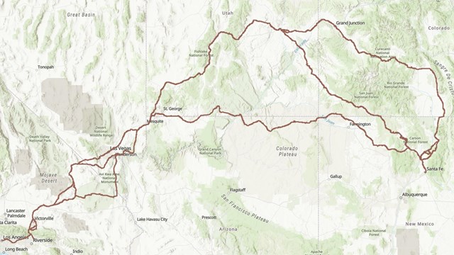 Map with green and brown shading. Brown lines from New Mexico to California show historic routes.