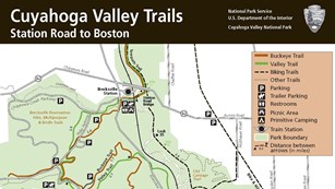 An excerpt of a green and white map of the park with black bar at top and dotted lines for trails.