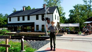 A ranger waves in front of the visitor center.