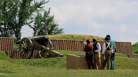 A Civil War reenactment with a cannon in the background at Fort Stevens. 