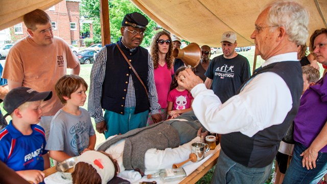 A reenactor doing a demonstration for park visitors at Fort Stevens. 