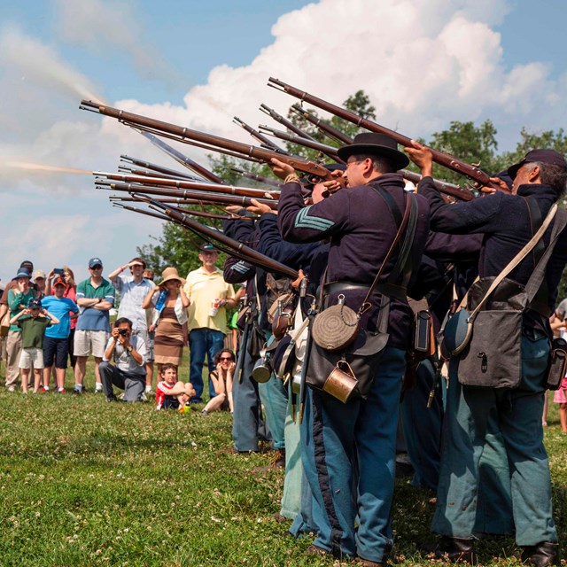 Visitors watch a Civil War reenactment at Fort Stevens