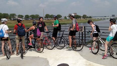 Bicyclists gathered at a river overlook