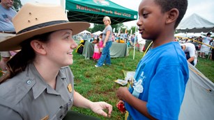 A boy talks to a ranger