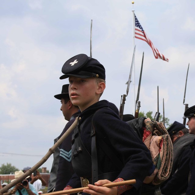Boy in Civil War union uniform.