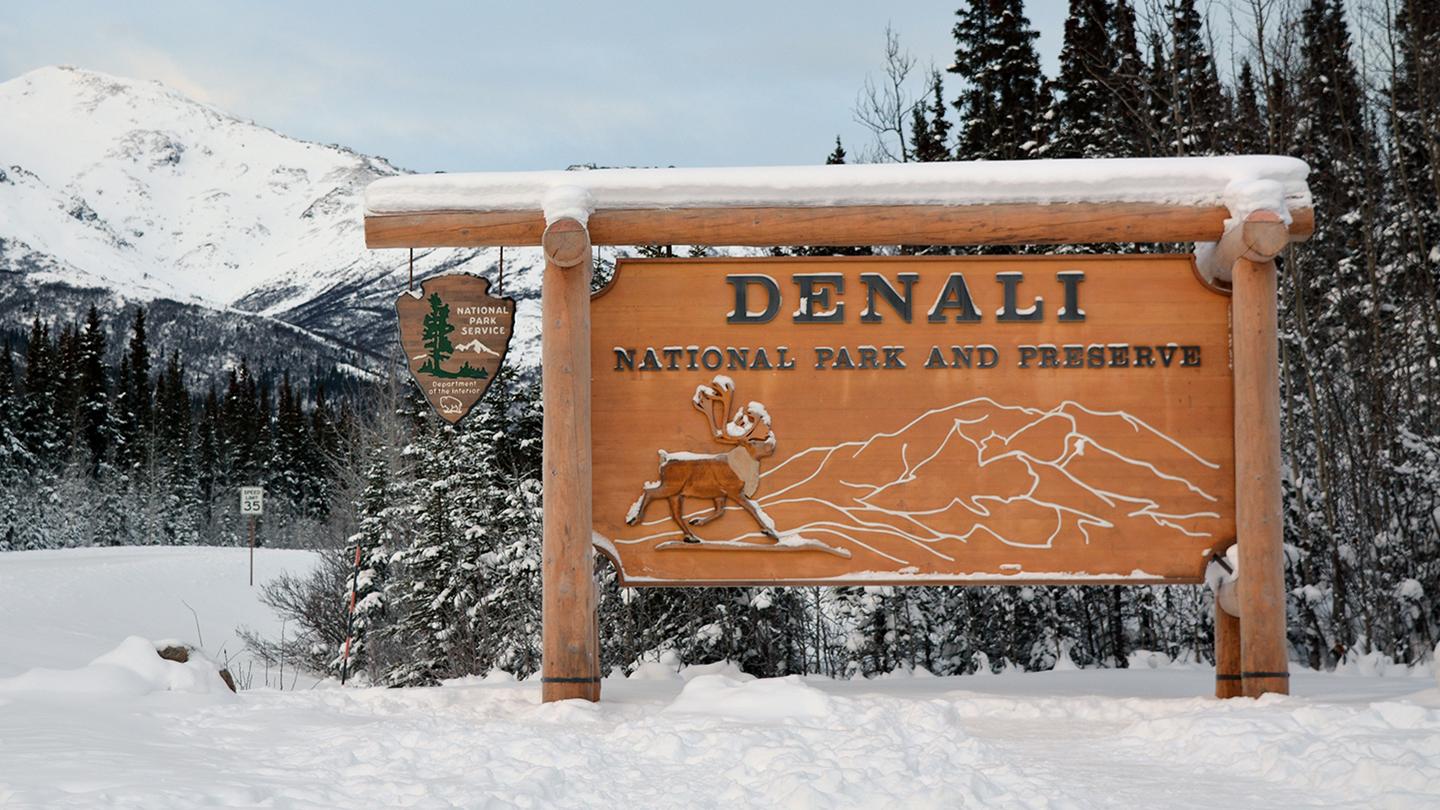 Denali National Park entrance sign in the snow