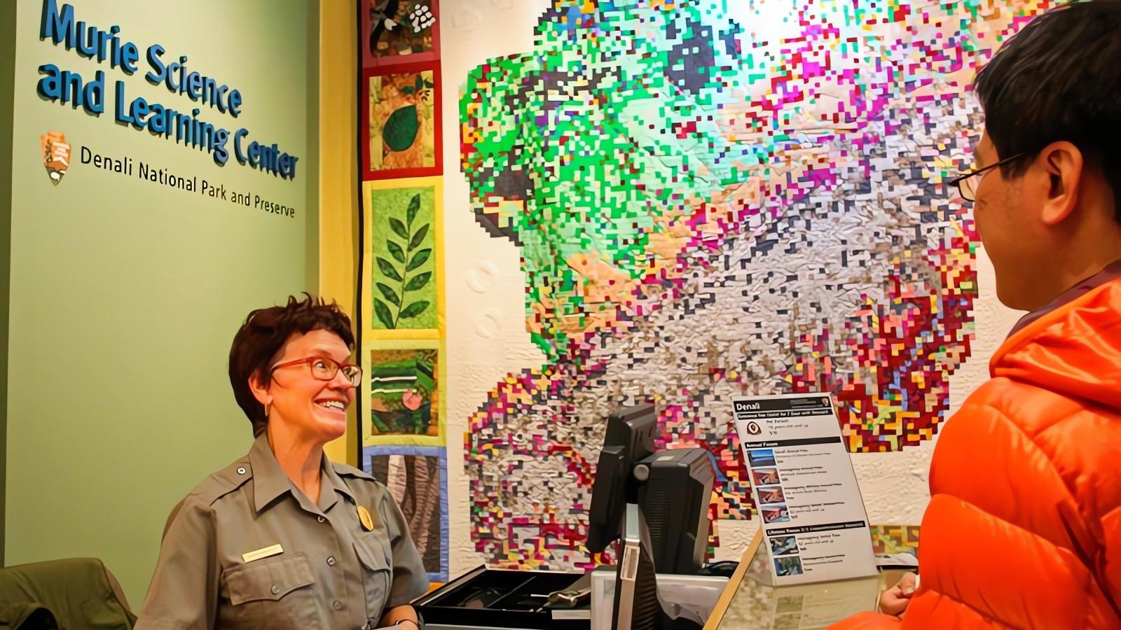 A park ranger greeting winter visitors at the Murie Science & Learning Center