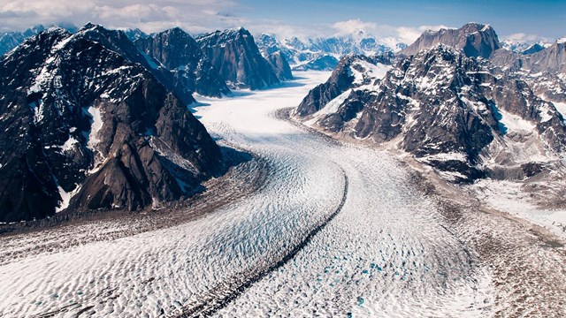a glacier weaves through mountains