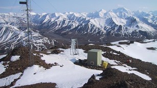earthquake monitoring equipment on a mountain top in the snow