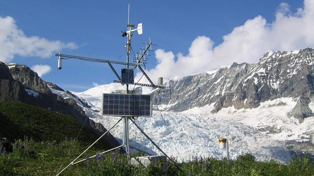 a climate station sits in front of a glacier
