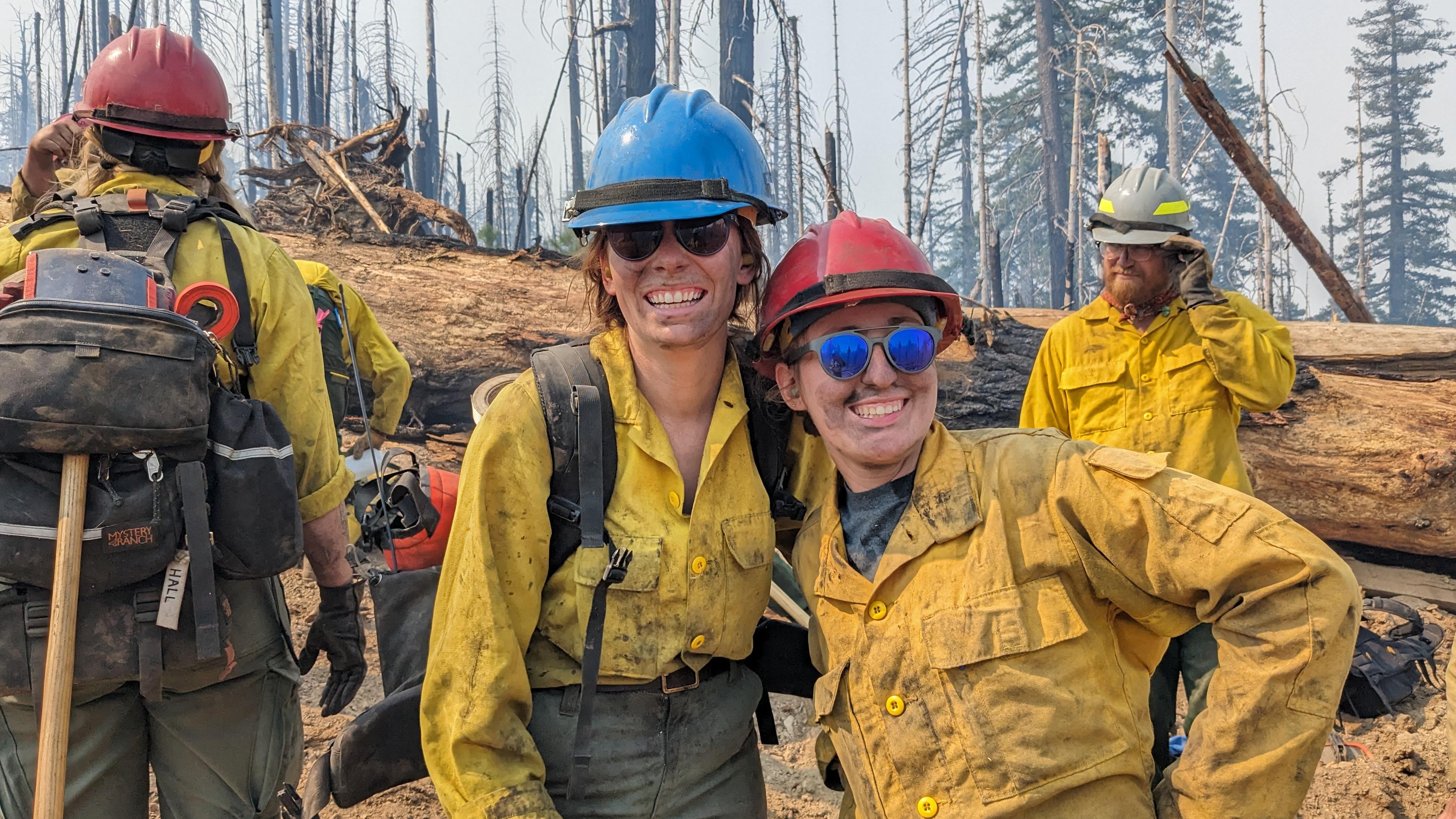 Two wildland firefighters posing for a picture