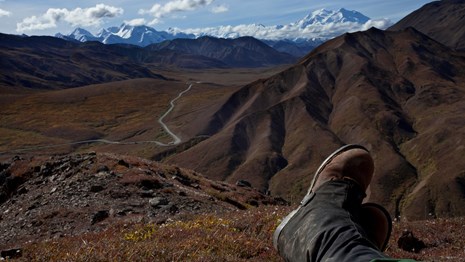 looking out towards the horizon over a valley and mountain range