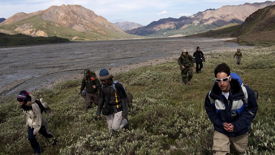 a group of students hike across the tundra