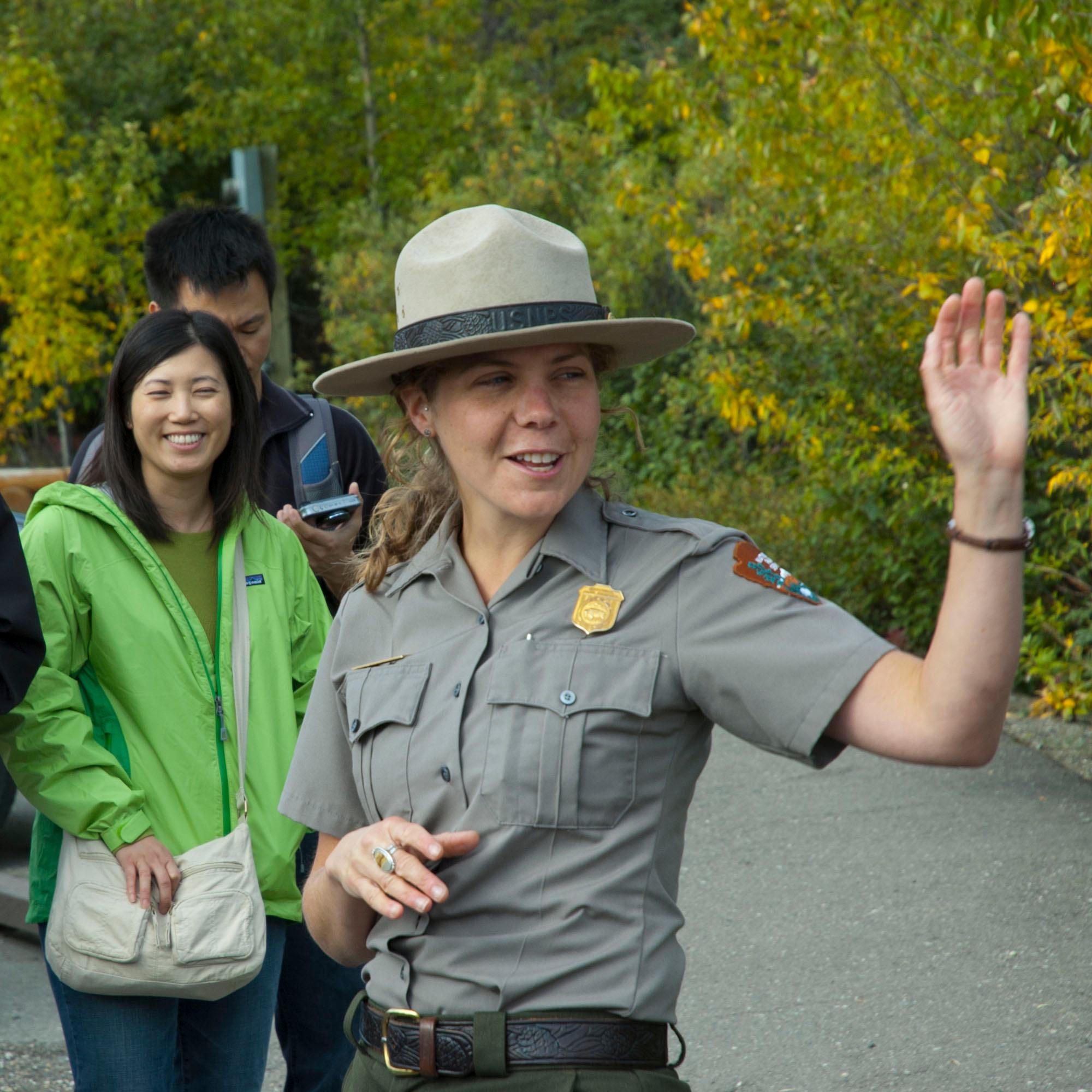 a ranger speaking to a crowd of people