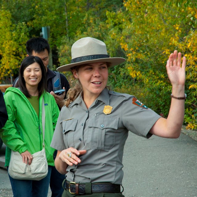 a ranger speaking to a crowd of people