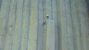 Two climbers scale Devils Tower
