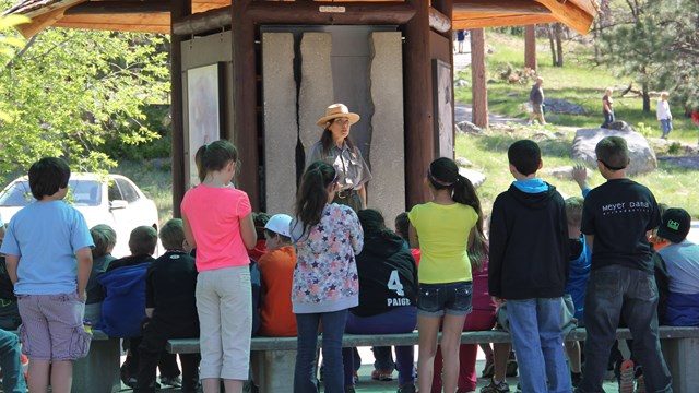 A ranger addressing a group of students