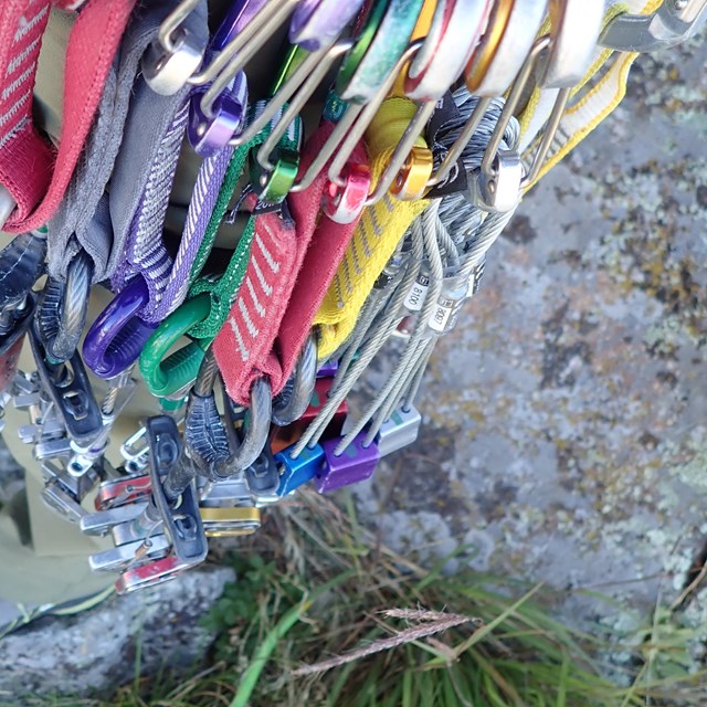 Climbing gear attached to the harness of a climber.