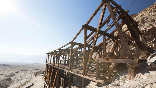 An old wooden mining structure in a desert landscape. 
