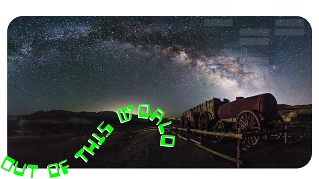 Night image with red light illuminating a wooden fence and historic wagon. Text "Out of this world".