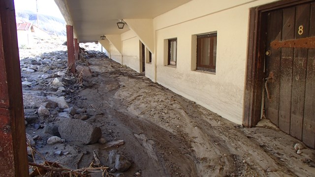 Mud halfway up white building walls.