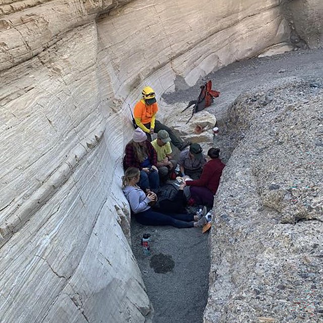 NPS responders assess the patient (lying down) while her companions support her..