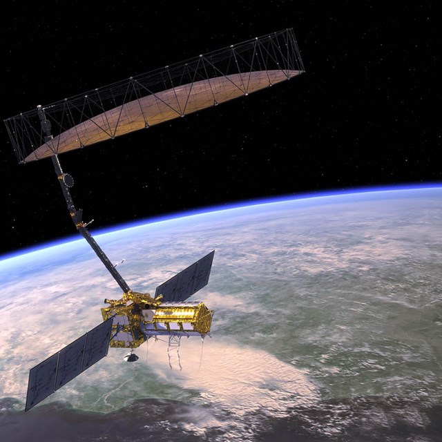 Artist's concept of a satellite floating in space above the earth.