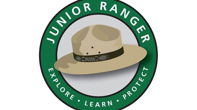 Junior Ranger Logo of ranger hat in a circle with the words junior ranger above and explore below 