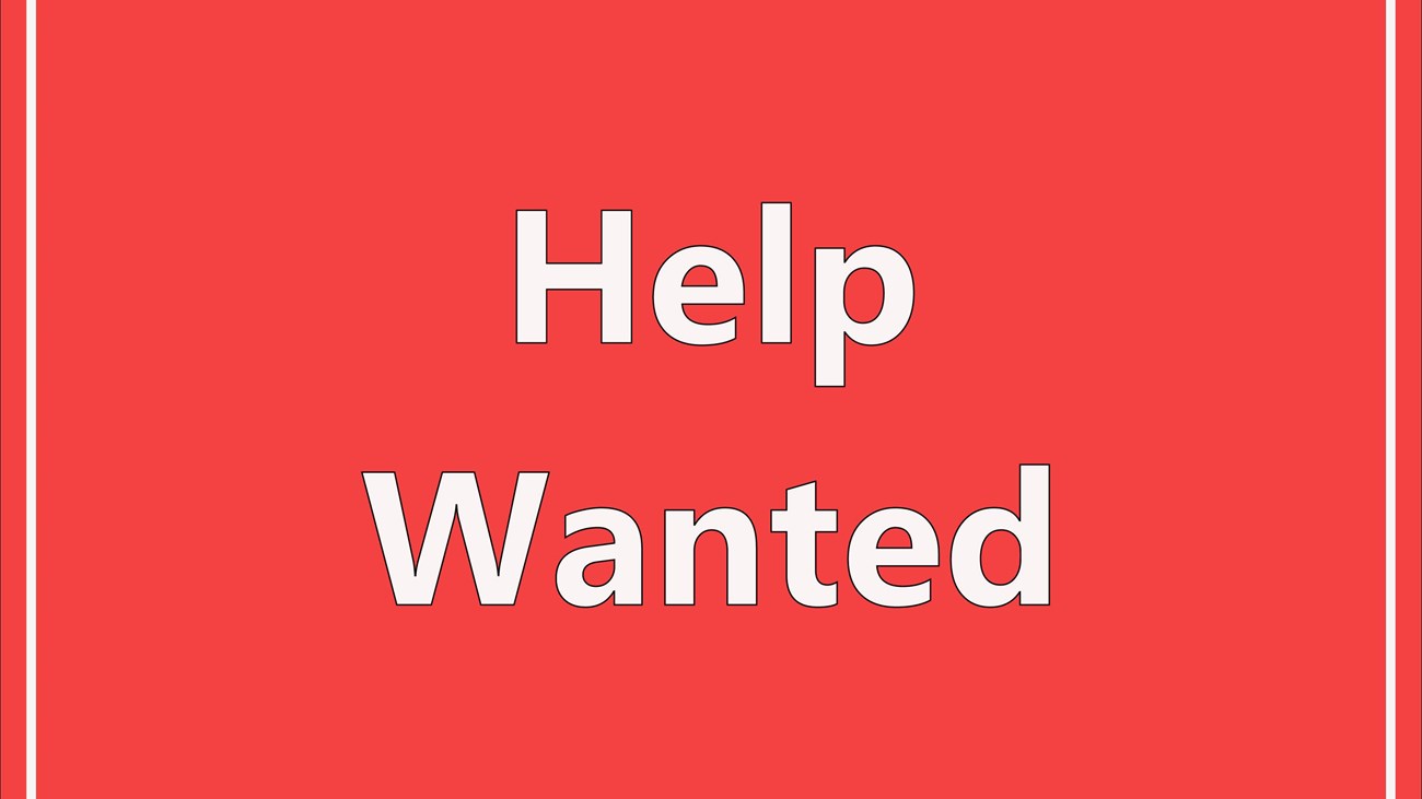 Image of a help wanted sign with lettering in the center and border strip around the sign 