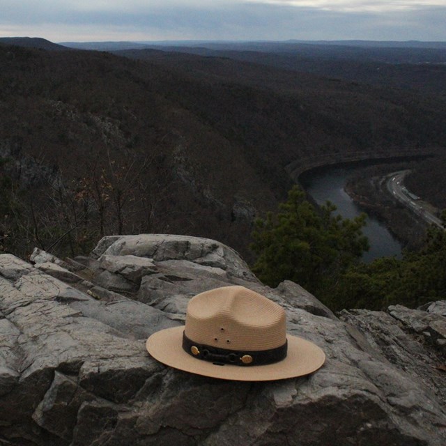 A ranger hat on top of Mount Tammany. A view of the gap is in the background.