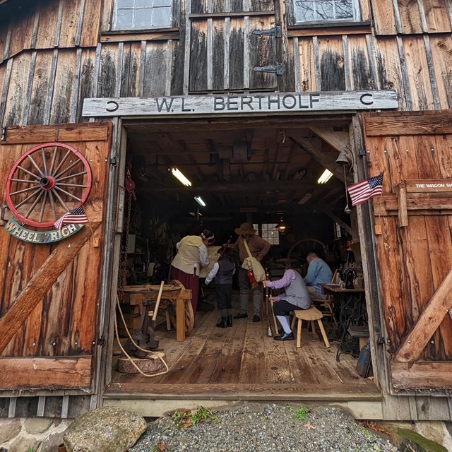 Volunteers teach people about history in an old wheel shop at Millbrook Village.