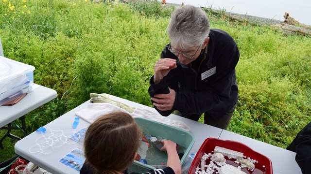 Washington State Park Ranger demonstrates marine life to kids.