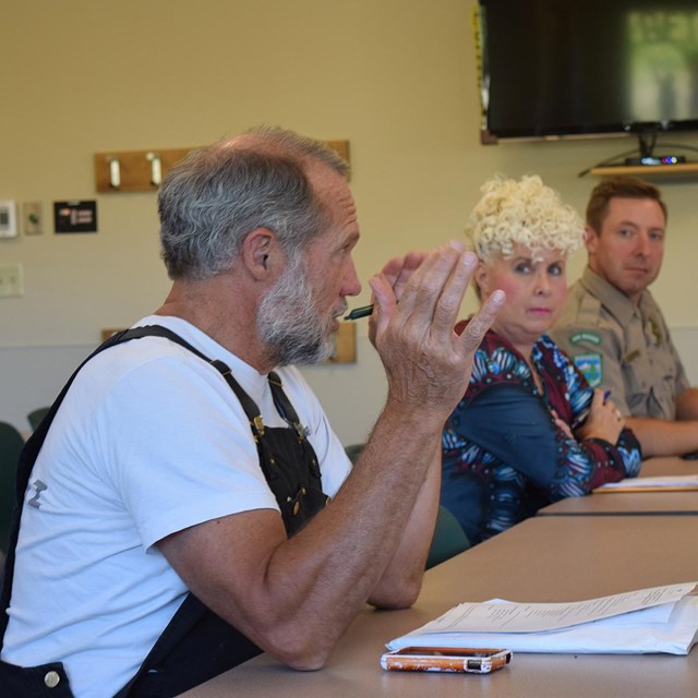 Trust board members sit around a table in the local library.