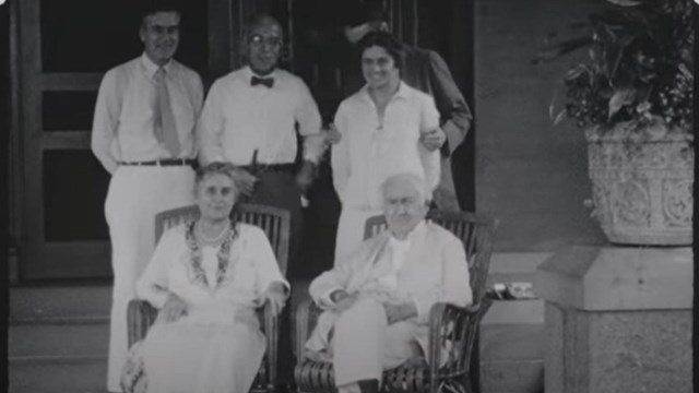 Black and white photo of Thomas Edison, seated in chair surrounded by his family