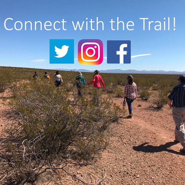 People walking down a trail in a desert setting with social media logos & 