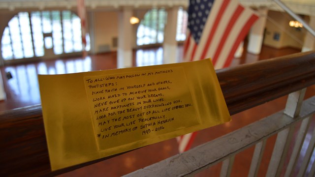  Gold Brick on Ellis Island Great Hall Railing with advice on life.