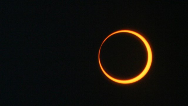 The moon outlined with by the sun during an eclipse creating a ring-like image.
