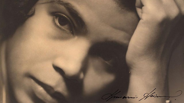 A close up portrait of Marian Anderson's face, her forehead leaning against an upright hand.