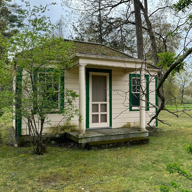 A small wood house with front porch.