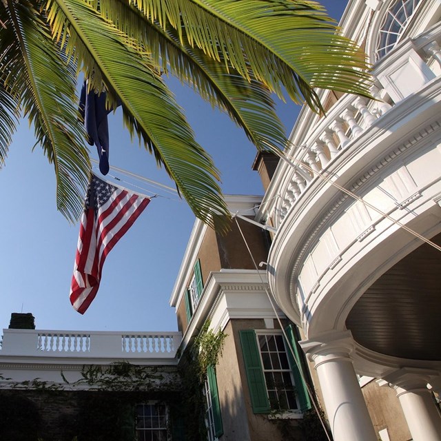 A rounded portico with the United States flag flying above.