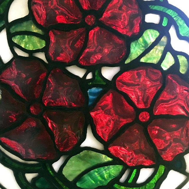 A mosaic of flowers made from colorful pieces of glass.