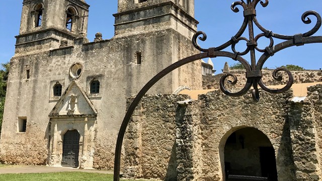 A weathered, grand, Spanish-colonial style mission.