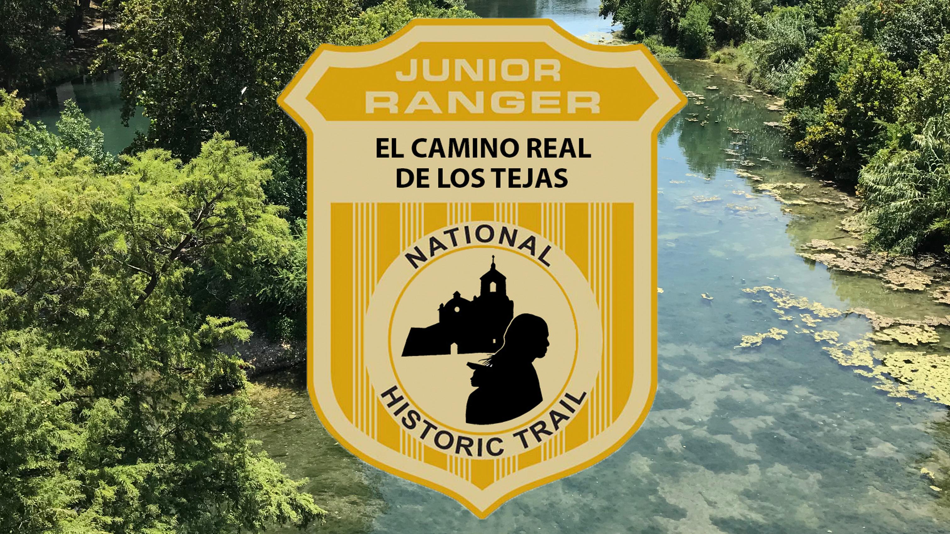 A shield badge with "junior range" set on an image of a clear creek running through a vegetated area