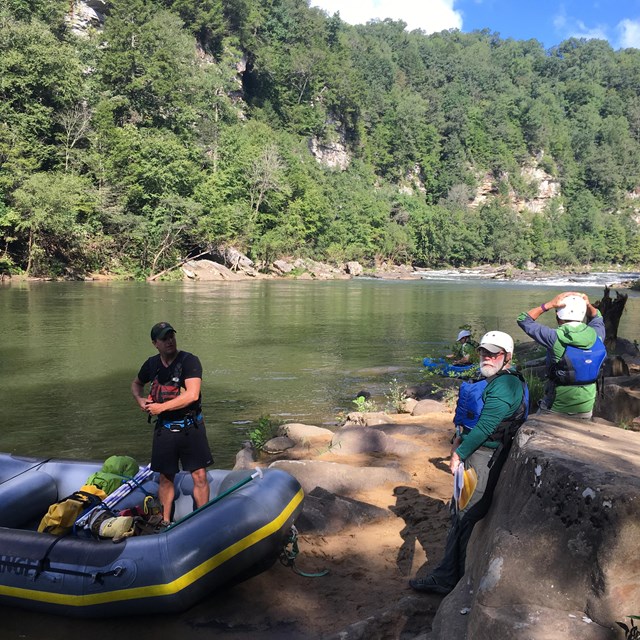 Monitoring crew preparing to board a raft