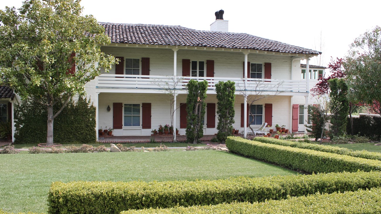 Hedges, trees and a courtyard next to the Eugene O'Neill home. 