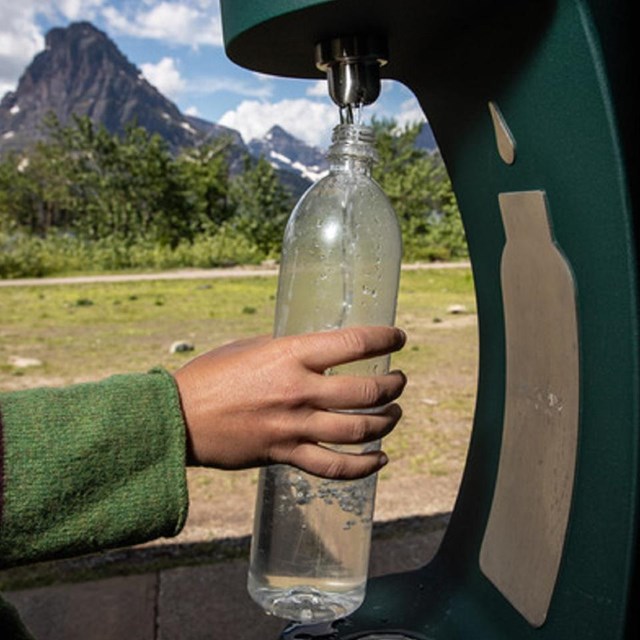 a water bottle filling station is used to refill a water bottle