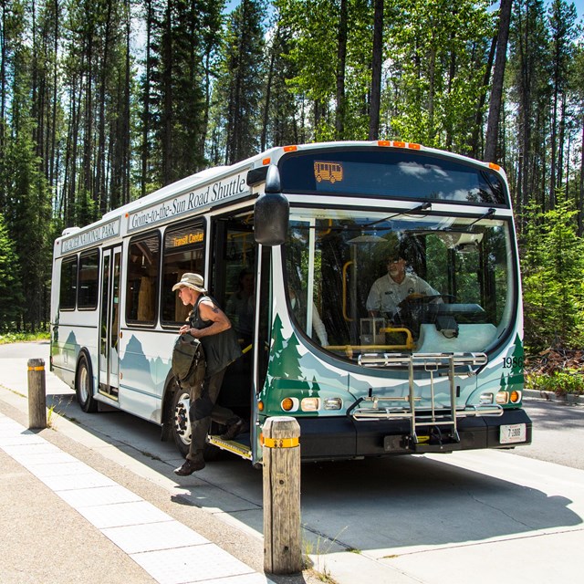 a person disembarks a bus that reads 